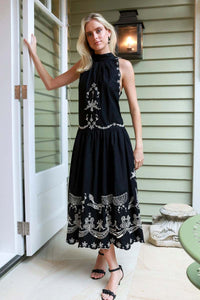 The Kingsley embroidered tank dress by SEA NY showcases intricate embroidery throughout its design, offering a refined and elegant appeal. It features a high neckline that adds a sophisticated touch, complemented by a delicate back bow tie for adjustable fit and added charm. The scalloped hemline enhances the dress's feminine silhouette, making it an exceptional choice for those seeking a polished yet distinctive look.
