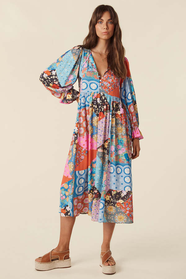 The Cha Cha Boho Midi Dress by Spell combines breathable, lightweight fabric with a refined design for ultimate comfort in warm weather. Its pull-on style and partial button front simplify dressing, while the tasseled tie neckline and cinched ruffled cuffs create a subtle, elegant bohemian aesthetic. This dress is an expert choice for those prioritizing both comfort and sophisticated style in their wardrobe.