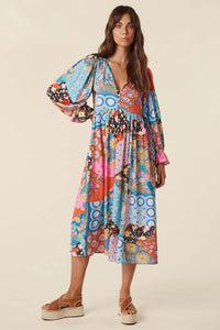 The Cha Cha Boho Midi Dress by Spell combines breathable, lightweight fabric with a refined design for ultimate comfort in warm weather. Its pull-on style and partial button front simplify dressing, while the tasseled tie neckline and cinched ruffled cuffs create a subtle, elegant bohemian aesthetic. This dress is an expert choice for those prioritizing both comfort and sophisticated style in their wardrobe.