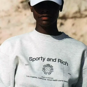 Elevate your casual wardrobe with the vintage-inspired Crewneck Sweatshirt! by Sporty & Rich Made from lightweight cotton, this loose-fitting sweatshirt features a unique round neck print and long sleeves. Perfect for a relaxed yet stylish look during the autumn season.