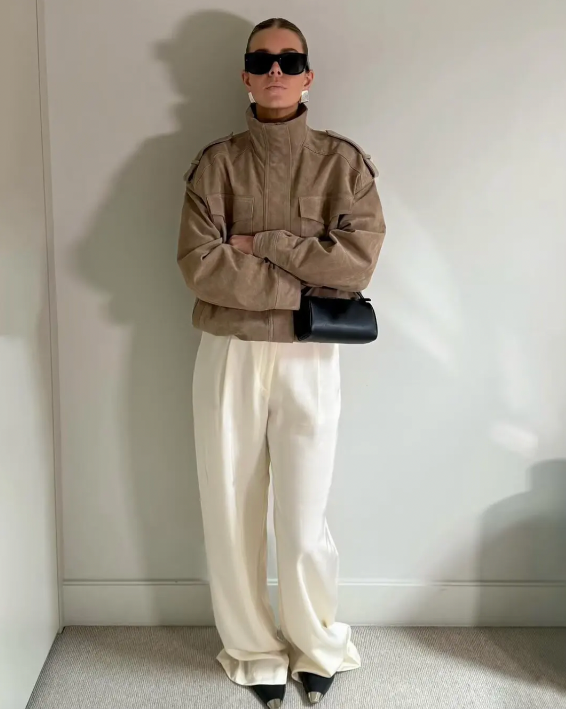 This Suede Jacket combines timeless sophistication with practical design. Crafted from soft suede leather, it features a high collar that provides extra warmth and a refined look. Long cuffed sleeves with shoulder tabs enhance its rugged appeal, while front and chest flap pockets offer convenient storage without sacrificing style. 