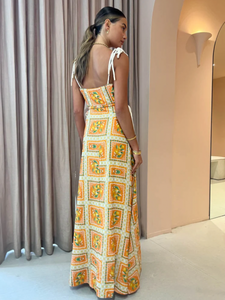 Embrace the essence of a Sicilian summer with the Lemonade Tie Maxi Dress in Orange Mosaic. Made from a breathable linen-cotton blend and fully lined, this dress offers comfort through long summer days. Its straight neckline and fitted bodice flatter the silhouette, while adjustable rope shoulder and waist ties provide a personalized fit. 