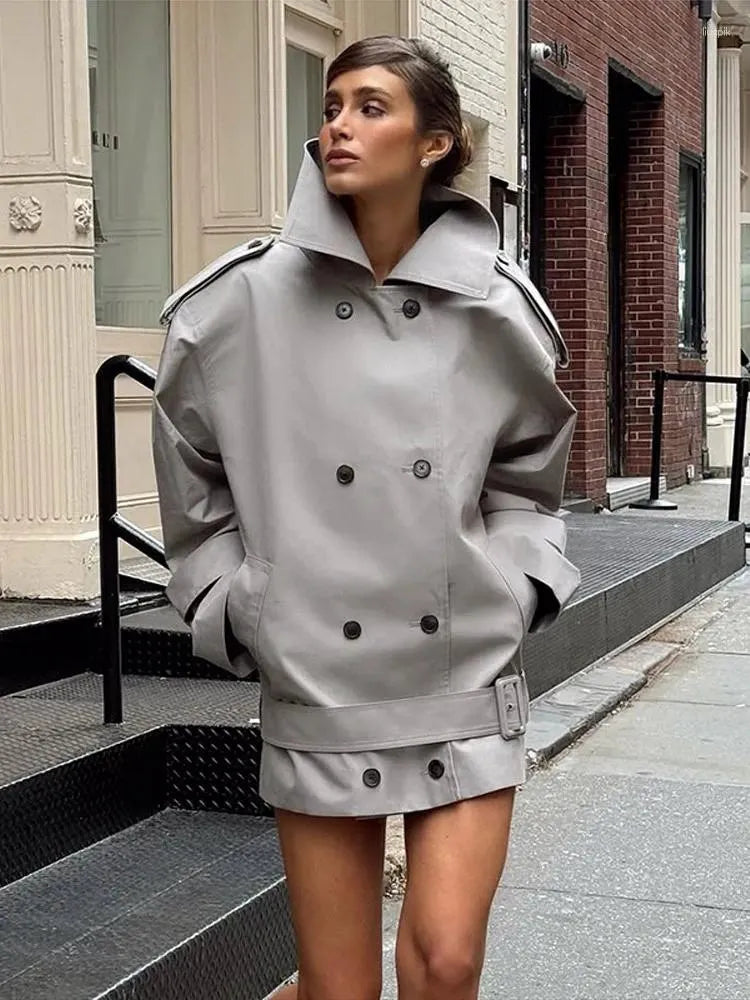 The Major Trench Jacket by Helsa combines timeless design with functional details for a sophisticated look. Crafted from durable gabardine, it features a front button closure and padded shoulders for comfort and structure. Epaulettes and belted cuffs enhance its refined style, while side seam pockets add practicality. An optional belt allows for a tailored fit, making this jacket a versatile layer suitable for all seasons. 