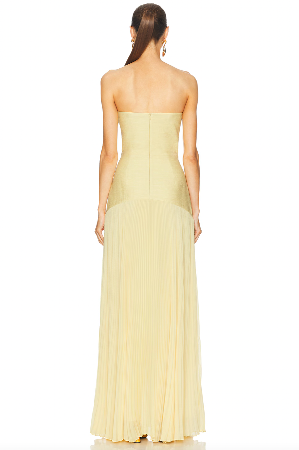 The Sunniva Dress features a fitted strapless bodice and a gracefully curved dropped waist that flows into a delicate plissé skirt. This elegant silhouette accentuates your figure while allowing ease of movement. Ideal for pairing with bold statement earrings, it creates a refined and modern look perfect for leaving a lasting impression at any event.