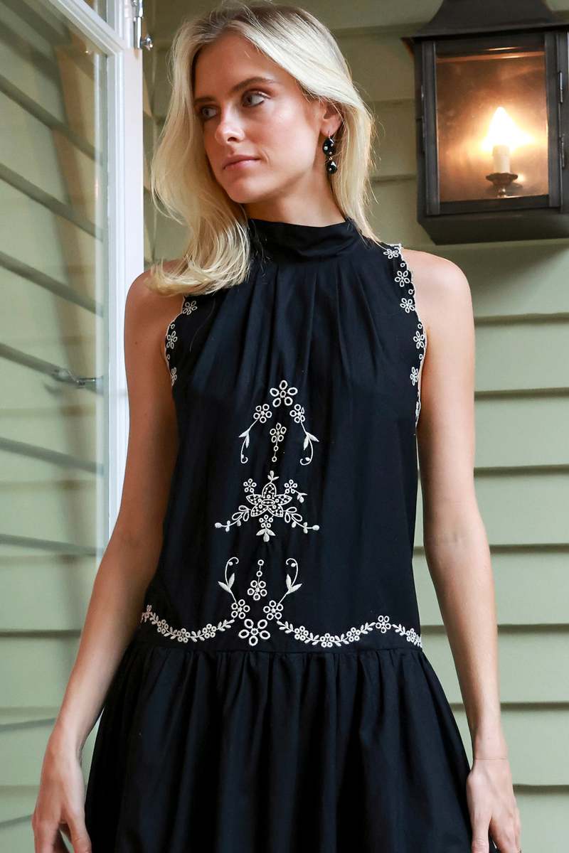 The Kingsley embroidered tank dress by SEA NY showcases intricate embroidery throughout its design, offering a refined and elegant appeal. It features a high neckline that adds a sophisticated touch, complemented by a delicate back bow tie for adjustable fit and added charm. The scalloped hemline enhances the dress's feminine silhouette, making it an exceptional choice for those seeking a polished yet distinctive look.
