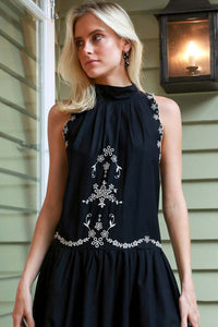 The Kingsley embroidered tank dress by SEA NY showcases intricate embroidery throughout its design, offering a refined and elegant appeal. It features a high neckline that adds a sophisticated touch, complemented by a delicate back bow tie for adjustable fit and added charm. The scalloped hemline enhances the dress's feminine silhouette, making it an exceptional choice for those seeking a polished yet distinctive look.