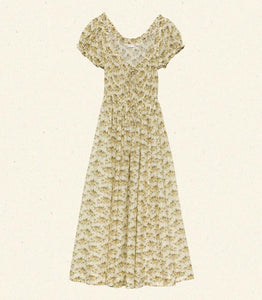Crafted from soft, lightweight organic cotton voile, the Ashlynn Dress in Citron Rosier Floral by Doen blends Victorian elegance with modern comfort. Featuring short puffed sleeves, a scoop neckline with a functional center tie, and delicate ruffled cuffs, this dress exudes vintage charm. The smocked bodice ensures a flattering fit, complemented by an adjustable waist tie, while the full, ankle-grazing skirt offers graceful movement. Ideal for those seeking refined style with breathable, sustainable fabric.