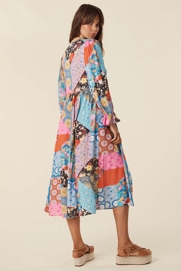 The Cha Cha Boho Midi Dress by Spell combines breathable, lightweight fabric with a refined design for ultimate comfort in warm weather. Its pull-on style and partial button front simplify dressing, while the tasseled tie neckline and cinched ruffled cuffs create a subtle, elegant bohemian aesthetic. This dress is an expert choice for those prioritizing both comfort and sophisticated style in their wardrobe.