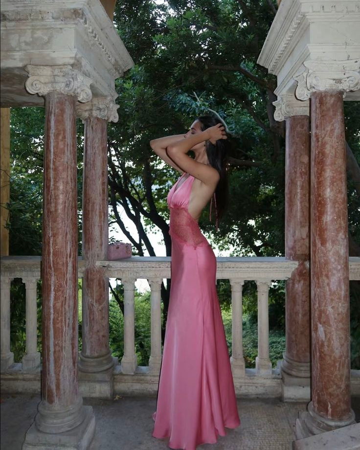 The Dinah Satin Dress offers a refined blend of elegance and allure with its halter tie V-neckline and softly gathered bust. Crafted with a sheer lace body that gracefully follows your silhouette, it features a dramatic low back and a maxi length for timeless sophistication. Partially lined and equipped with an invisible zip, this dress ensures a flawless fit and subtle coverage, perfect for making a confident statement at any special occasion.