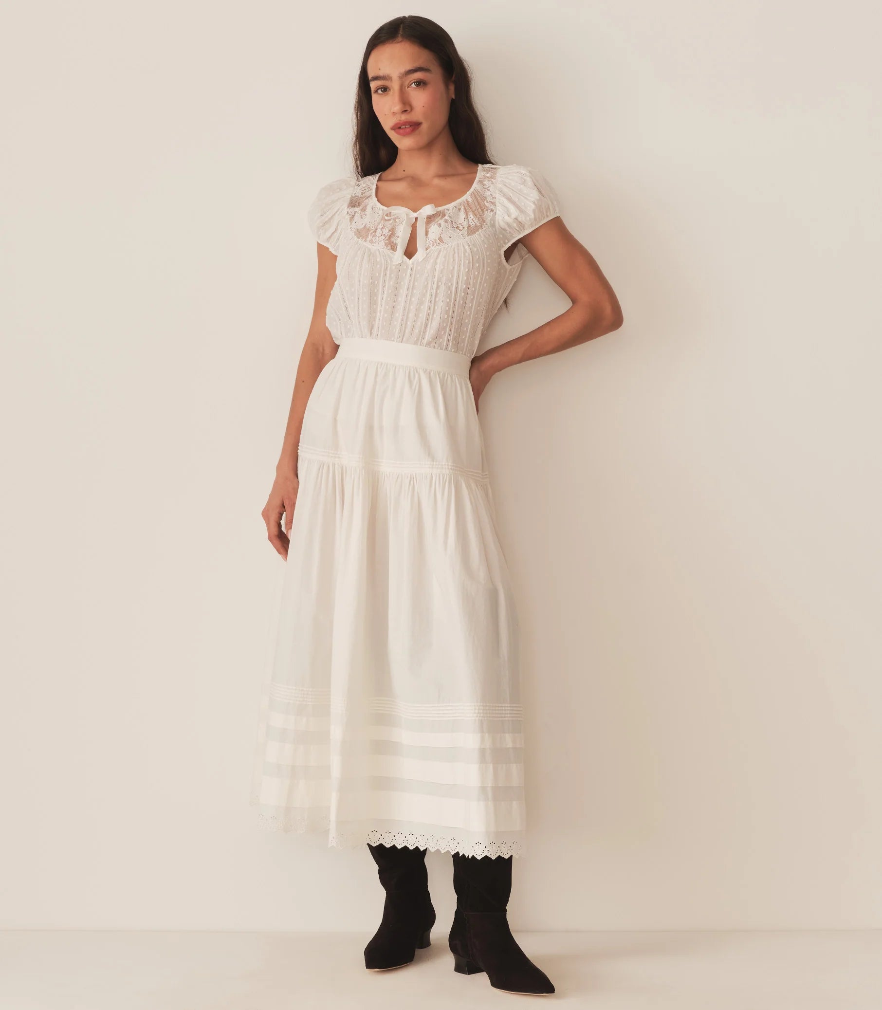 The DOEN Camri Top features a refined design with short sleeves and elegant tie detailing, offering a versatile and sophisticated look. Crafted for comfort and style, it pairs effortlessly with both casual and dressier outfits, making it an essential addition to your wardrobe.