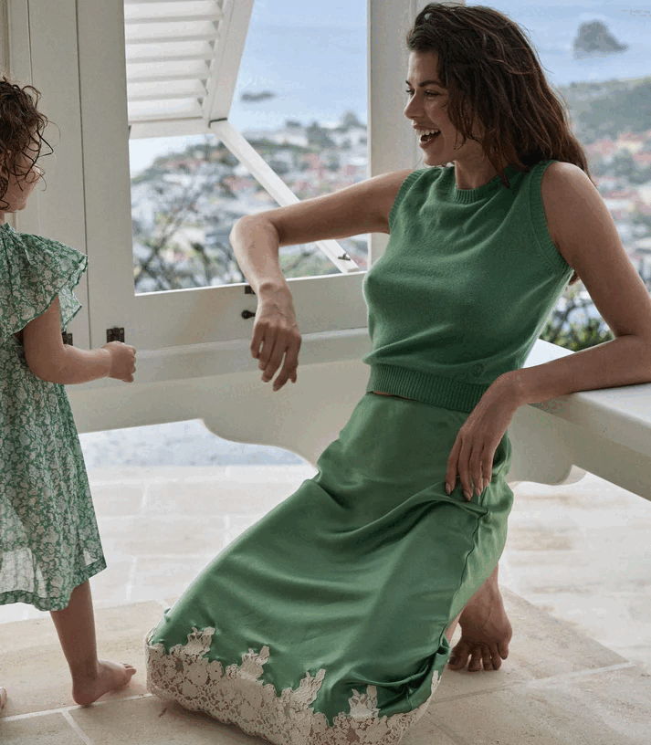Crafted from buttery silk satin, the Elowena Skirt in Peridot by Doen offers a sophisticated silhouette with a high waist accented by elastic scallop trim for added comfort and subtle texture. Its flowing bias cut ensures graceful movement, while the detailed contrast floral lace at the hem elevates the design with refined elegance. Ideal for pairing with the Kira Top, this skirt merges classic craftsmanship with contemporary style for a polished, expert look.