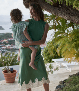 Crafted from buttery silk satin, the Elowena Skirt in Peridot by Doen offers a sophisticated silhouette with a high waist accented by elastic scallop trim for added comfort and subtle texture. Its flowing bias cut ensures graceful movement, while the detailed contrast floral lace at the hem elevates the design with refined elegance. Ideal for pairing with the Kira Top, this skirt merges classic craftsmanship with contemporary style for a polished, expert look.