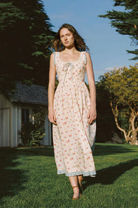 Inspired by Edwardian corsets, the Eliana Dress combines classic sophistication with contemporary ease. Made from 100% organic cotton, this sleeveless midi features an exaggerated wide scoop neckline adorned with contrasting eyelet trim and soft ruffles. A half-functional front button placket and subtle micro pintucks at the bust provide elegant accents, while the lace-up back creates a striking, form-fitting silhouette. 