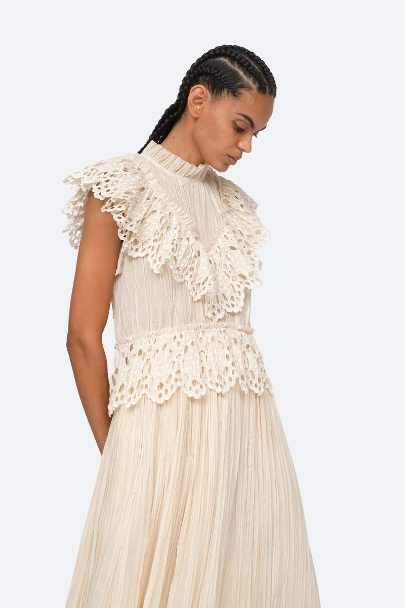 Indulge in luxury with the Cream Elise Eyelet Top by SEA. Featuring flutter sleeves and oversized eyelet detailing, this pleated top exudes elegance and sophistication. Perfect for any occasion, it effortlessly elevates your style. Add it to your wardrobe for a touch of exclusivity.