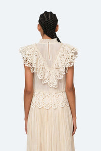 Indulge in luxury with the Cream Elise Eyelet Top by SEA. Featuring flutter sleeves and oversized eyelet detailing, this pleated top exudes elegance and sophistication. Perfect for any occasion, it effortlessly elevates your style. Add it to your wardrobe for a touch of exclusivity.