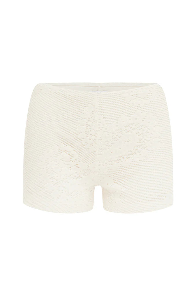 Elevate your wardrobe with the Dom Set by With Jean, expertly combining refined craftsmanship and elegant design. The Dom Top is a long-sleeve cardigan featuring a button-up front, a polished neckline collar, and delicate scalloped trim, enhanced by custom hand-drawn crochet lace for a sophisticated finish. Complementing the top, the Dom Shorts offer comfort with a fully lined interior and an elasticated waistband, adorned entirely with the same intricate crochet lace. 