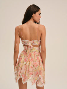 Elevate your summer wardrobe with the Elea Mini Dress, a delicate blend of romance and sophistication. This peach floral mini dress features structured underwire cups and a boned bodice for refined support and shape. Its multi-layered asymmetrical skirt gathers gracefully, ending with lace ruffles that add a subtle touch of elegance. Perfect for warm days and special occasions, the Elea Mini Dress offers a flattering silhouette that embodies effortless femininity.