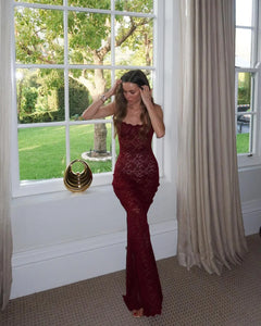 Indulge in the luxurious and alluring Margot Lace Dress. Made from vintage-inspired lace in a deep Wine shade, Margot exudes elegance and allure. Featuring a floor length maxi with a split, adjustable gold fastenings, and a semi-sweetheart neckline, she is designed to flatter your figure. Lined at the bust for coverage and support, Margot is the timeless and sheer look you need for any special occasion.