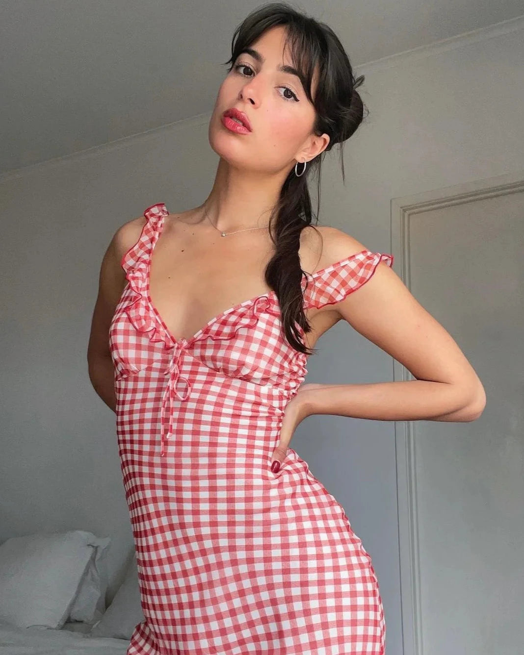 Add a touch of sweetness and playfulness to your wardrobe with the Heidi Dress in gingham. Featuring a charming frilled neckline, non-adjustable bust tie, and adjustable straps for the perfect fit. Fully lined and slip on style for easy wearability. Feel confident and carefree in this must-have dress!