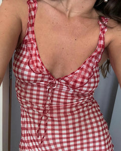 Add a touch of sweetness and playfulness to your wardrobe with the Heidi Dress in gingham. Featuring a charming frilled neckline, non-adjustable bust tie, and adjustable straps for the perfect fit. Fully lined and slip on style for easy wearability. Feel confident and carefree in this must-have dress!