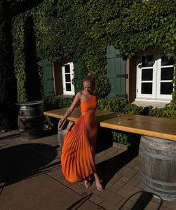The Delfina Dress by ALC features an elegant one-shoulder design with a subtle side cut-out that adds a modern touch. Crafted from flowy pleated satin, its asymmetrical hem enhances movement and grace, making it perfect for sophisticated occasions.