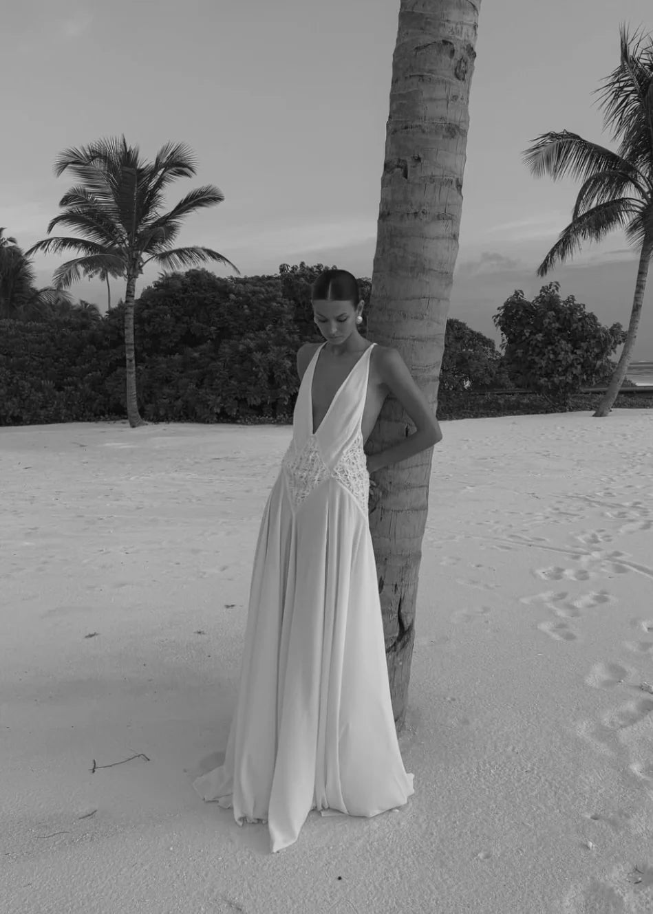 The Lavinia Dress by Arcina Ori exudes effortless elegance with its plunging V-neckline adorned by delicate lace accents. Adjustable straps converge into a graceful open back, enhancing its feminine appeal. Crafted from lightweight georgette, the ruched skirt flows gently, offering a fluid silhouette that moves with ease. Ideal for intimate gatherings or romantic moments, Lavinia blends sophistication with comfort for the modern muse.
