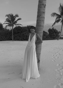 The Lavinia Dress by Arcina Ori exudes effortless elegance with its plunging V-neckline adorned by delicate lace accents. Adjustable straps converge into a graceful open back, enhancing its feminine appeal. Crafted from lightweight georgette, the ruched skirt flows gently, offering a fluid silhouette that moves with ease. Ideal for intimate gatherings or romantic moments, Lavinia blends sophistication with comfort for the modern muse.