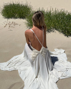 The Lavinia Dress by Arcina Ori exudes effortless elegance with its plunging V-neckline adorned by delicate lace accents. Adjustable straps converge into a graceful open back, enhancing its feminine appeal. Crafted from lightweight georgette, the ruched skirt flows gently, offering a fluid silhouette that moves with ease. Ideal for intimate gatherings or romantic moments, Lavinia blends sophistication with comfort for the modern muse.
