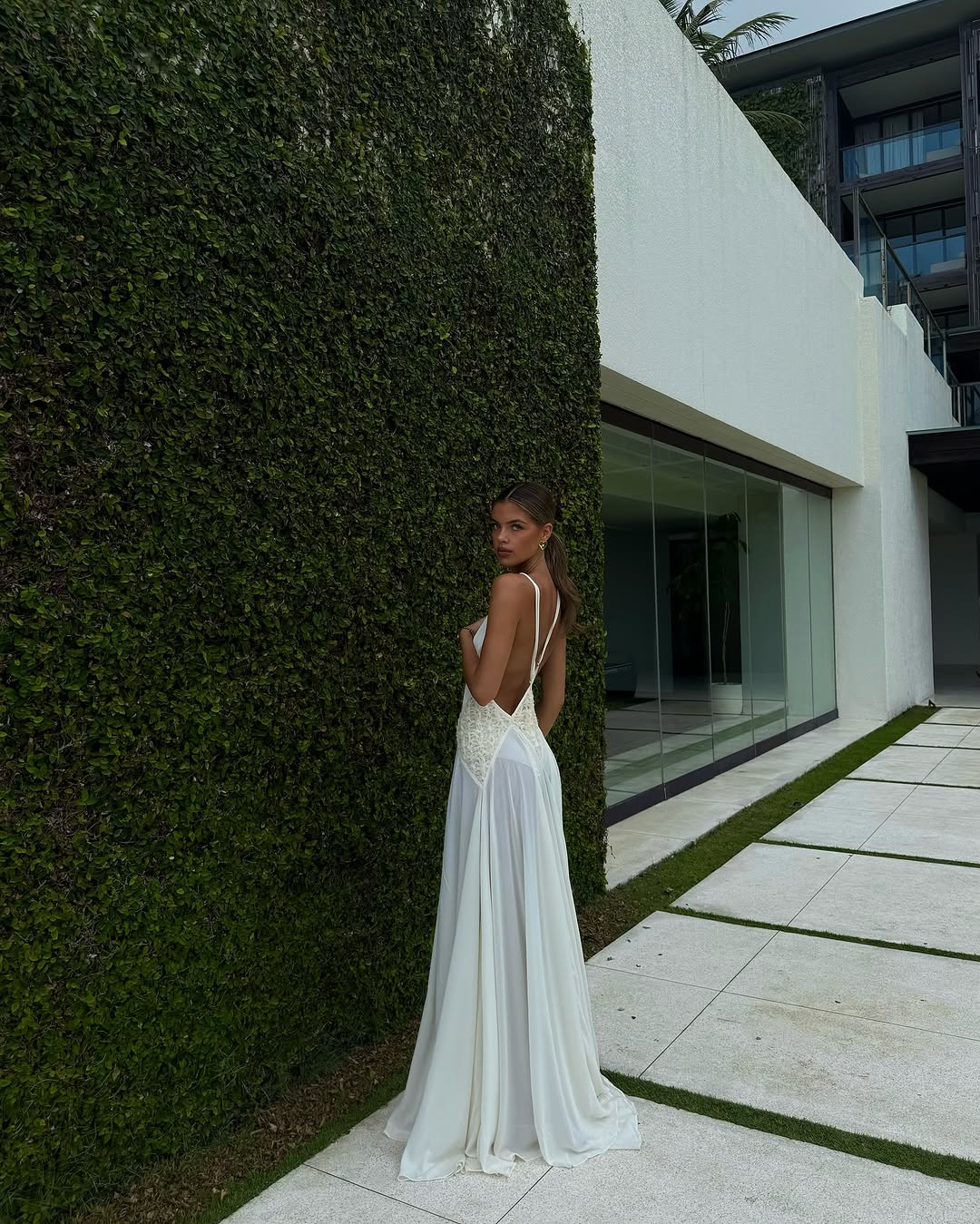 The Lavinia Dress by Arcina Ori exudes effortless elegance with its plunging V-neckline adorned by delicate lace accents. Adjustable straps converge into a graceful open back, enhancing its feminine appeal. Crafted from lightweight georgette, the ruched skirt flows gently, offering a fluid silhouette that moves with ease. Ideal for intimate gatherings or romantic moments, Lavinia blends sophistication with comfort for the modern muse.