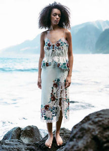 The Katharine Skirt showcases a sophisticated asymmetrical front slit complemented by delicate self ties, enhancing its elegant silhouette. Crafted with intricate floral lace and detailed embroidery, this skirt offers a refined texture and visual appeal. Designed to coordinate seamlessly with the Katharine embroidered slip top, it provides a polished, cohesive look ideal for elevated occasions.