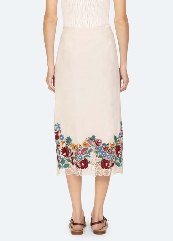 The Katharine Skirt showcases a sophisticated asymmetrical front slit complemented by delicate self ties, enhancing its elegant silhouette. Crafted with intricate floral lace and detailed embroidery, this skirt offers a refined texture and visual appeal. Designed to coordinate seamlessly with the Katharine embroidered slip top, it provides a polished, cohesive look ideal for elevated occasions.