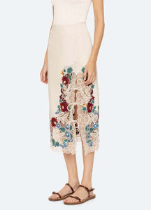 The Katharine Skirt showcases a sophisticated asymmetrical front slit complemented by delicate self ties, enhancing its elegant silhouette. Crafted with intricate floral lace and detailed embroidery, this skirt offers a refined texture and visual appeal. Designed to coordinate seamlessly with the Katharine embroidered slip top, it provides a polished, cohesive look ideal for elevated occasions.
