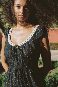 The Kelly Dress features a sophisticated deep scooped neckline trimmed with delicate lace, enhancing its feminine appeal. Crafted from 100% regenerative cotton, its elastic-gathered bodice ensures comfort and flexibility. Practical side seam pockets add functionality, while the exclusive Night Garden floral print completes this season’s standout silhouette with elegance and sustainability.