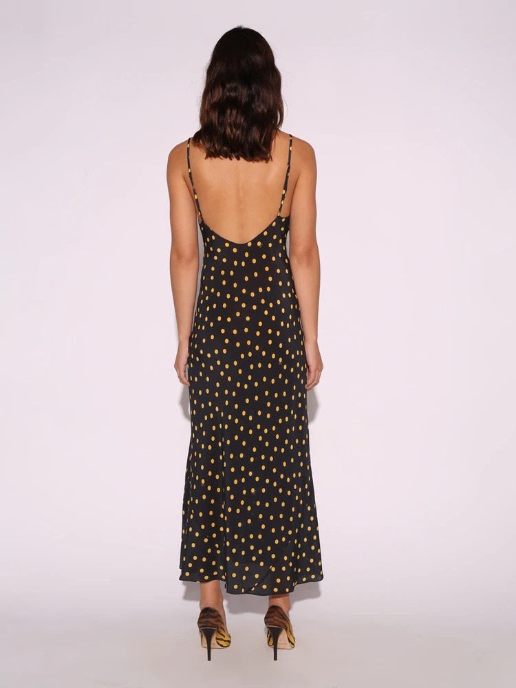 Elevate your style with the Merryl Slip Dress. This 90's inspired piece boasts a flattering ankle length and fish-tail hem, with a scooped bust and low back for a touch of allure. Made from 100% silk crepe, the bias cut skirt drapes beautifully for a sleek and luxurious feel. Adjust the back straps for the perfect fit.