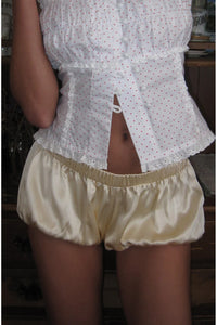 Crafted from 100% silk charmeuse with a fully lined interior, these Bloomer Shorts offer a luxurious feel and smooth finish. Featuring a pull-on design with elastic at the waistband and leg openings, they provide a comfortable and secure fit. The low-waisted, bubble balloon silhouette adds a distinctive, elegant shape perfect for sophisticated layering or standalone wear.