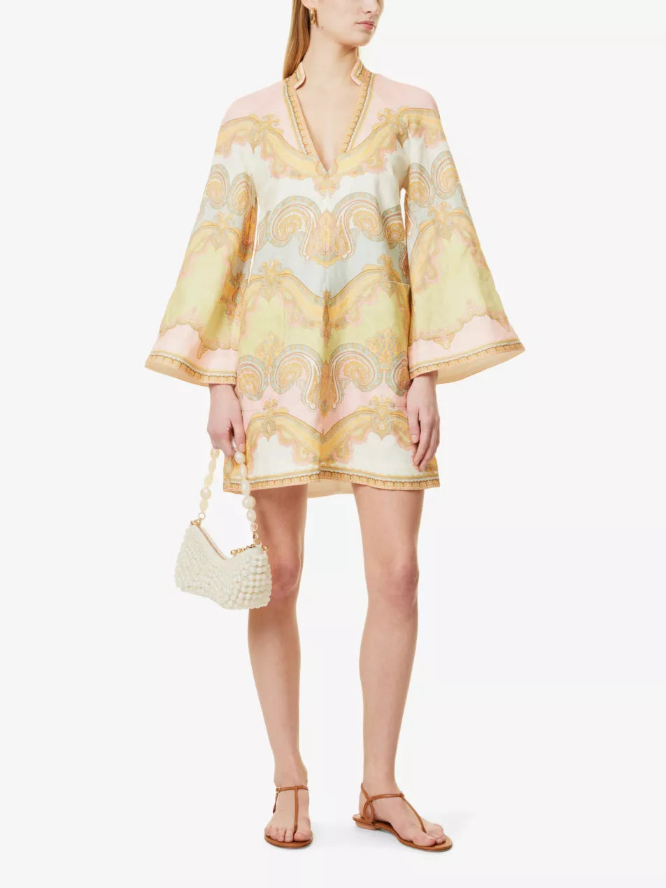 The Maxine Paisley-Pattern Tunic Linen Mini Dress by Zimmermann features tiers of breathable linen, delicate paisley embroidery, and vibrant prints that create a graceful, feminine look. Perfect for both beach days and stylish outings, its ruffled details add subtle elegance while keeping comfort in mind. Elevate your wardrobe effortlessly with this versatile dress that blends romantic charm with everyday sophistication.