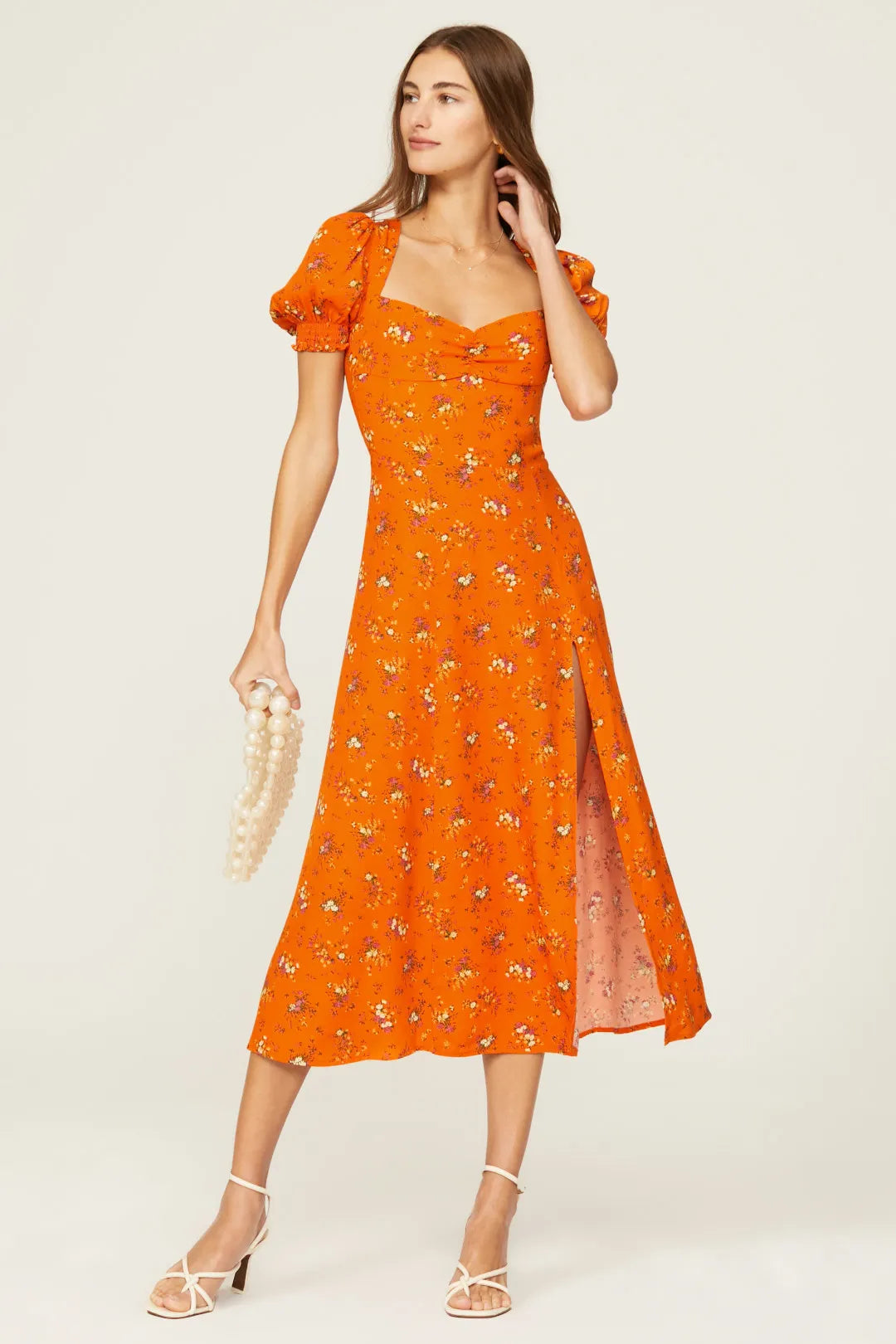 Expertly designed by Reformation, the Lacey Dress boasts delicate florals, puff sleeves, and a thigh-grazing slit. Elevate your style with this charming midi and add a sweet touch to any occasion. With its unique features, this dress is perfect for those who appreciate both fashion and comfort.