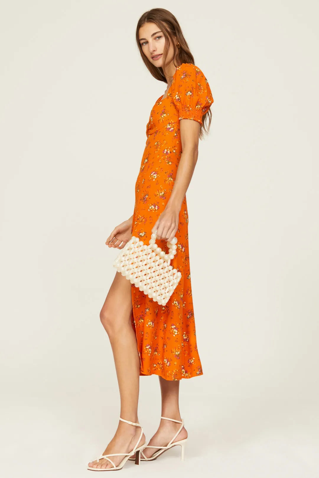 Expertly designed by Reformation, the Lacey Dress boasts delicate florals, puff sleeves, and a thigh-grazing slit. Elevate your style with this charming midi and add a sweet touch to any occasion. With its unique features, this dress is perfect for those who appreciate both fashion and comfort.