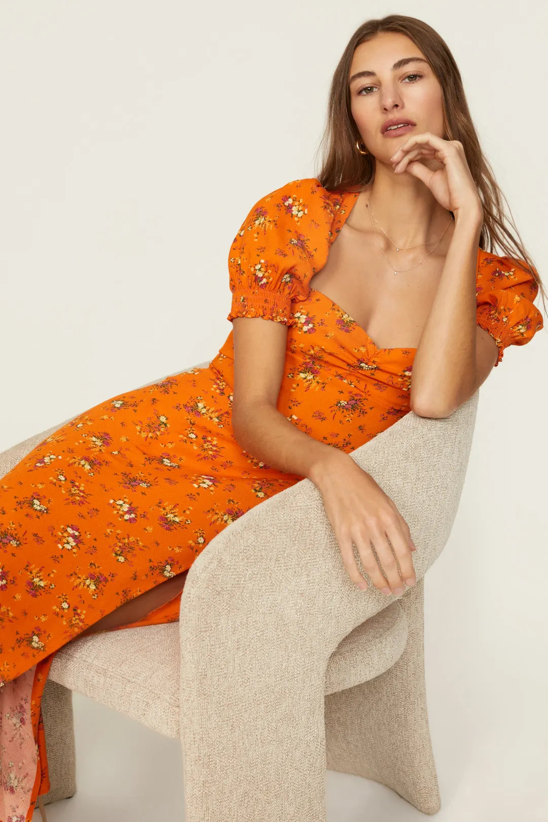 Expertly designed by Reformation, the Lacey Dress boasts delicate florals, puff sleeves, and a thigh-grazing slit. Elevate your style with this charming midi and add a sweet touch to any occasion. With its unique features, this dress is perfect for those who appreciate both fashion and comfort.