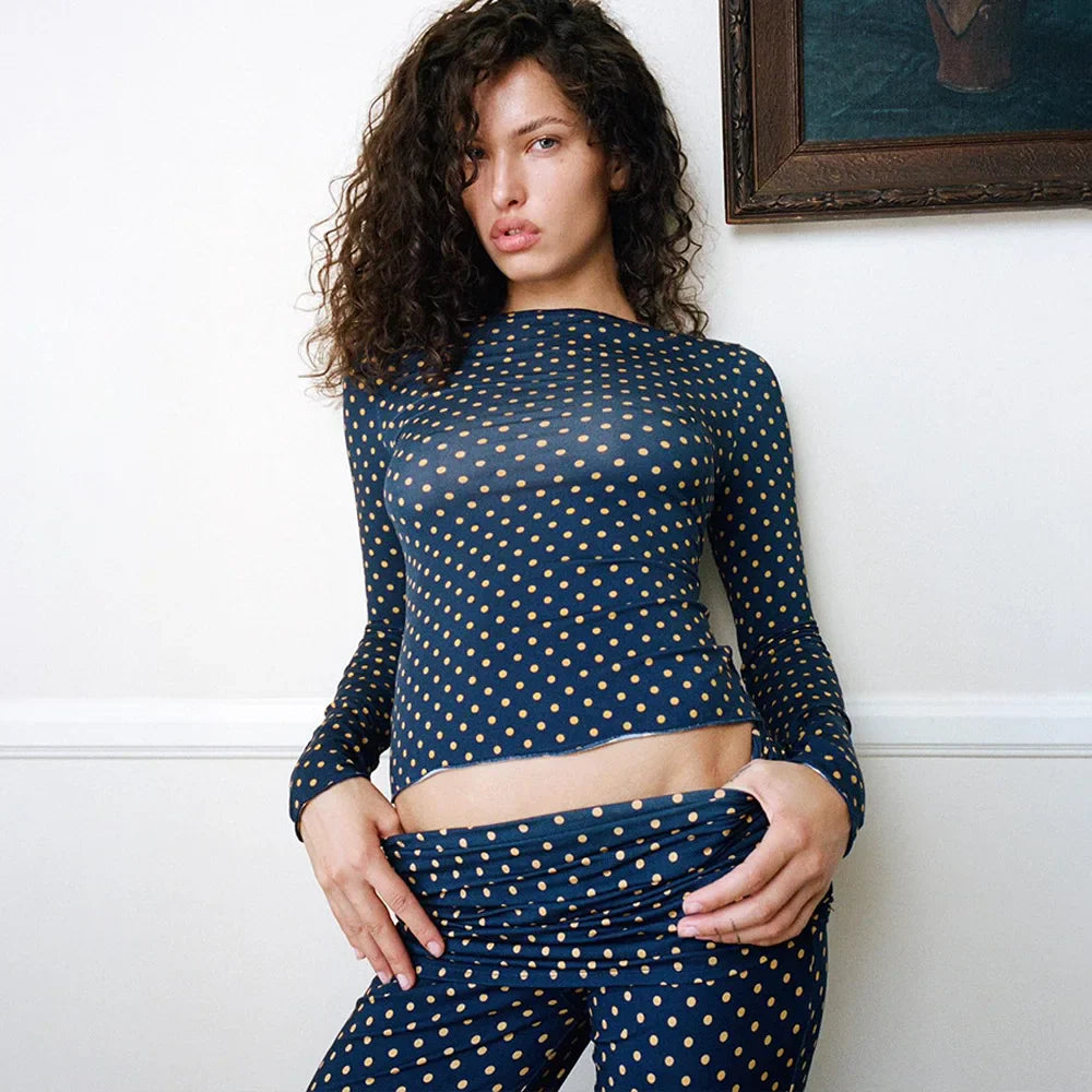 Introducing the Alana Set in Polka Dot. This mid-rise pant and top features a sheer fabric with a subtle flare at the bottom. The waist can also be folded over for added style. Perfect for everyday wear.