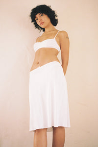 The Slip Skirt by Cou Cou Intimates offers a fresh take on a timeless silhouette, expertly designed for comfort and movement. Crafted to enhance your daily wardrobe, it features a delicate flounce hem and scalloped picot trim that add subtle charm. The petite baby bow at the center front adds a refined touch, while the pull-on style ensures effortless wear. Ideal for graceful twirls or casual days, this skirt balances elegance with ease.