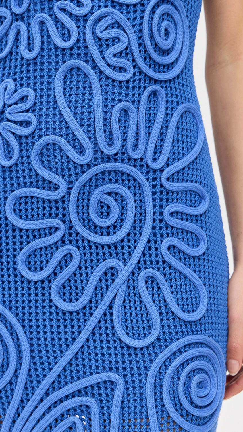 Crafted from mid-weight stretch crochet, the Nissa Knit Dress by Cult Gaia offers a comfortable fit with subtle elasticity. Its corded floral detailing adds refined texture and visual interest, while the midi length delivers elegant coverage. Featuring a square neckline and a seamless pullover design, this dress combines effortless wearability with sophisticated styling. Ideal for those seeking a balance of structure and flexibility in a distinctive, expert-crafted piece.