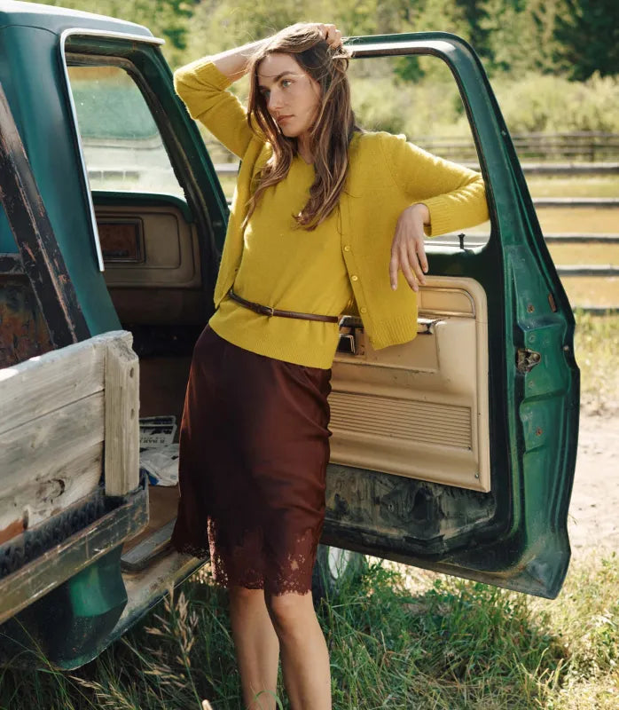 Crafted from luxurious silk satin, the Elowette Skirt in Cafe Brun by Doen features a bias-cut design that drapes beautifully for a refined silhouette. Its scalloped elastic high waist ensures both comfort and fit, while the delicate floral lace trim at the hem adds subtle sophistication. This midi-length skirt seamlessly transitions between casual and formal settings, making it a versatile addition to your wardrobe. Pair with a fitted top to create an expert polished look suited for day-to-night wear.