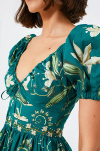 The Esmeralda Manzanilla Mini Dress combines effortless style with comfort, crafted from breathable 100% cotton poplin. Its adjustable deep-v neckline with a delicate drawstring ensures a custom fit, while the hand-embroidered waistline adds a refined artisanal touch. Featuring a concealed back zip for a seamless silhouette, this dress is perfect for warm days and tropical evenings. Elevate your look by pairing it with espadrilles or heels and statement jewelry for a polished, vibrant outfit.