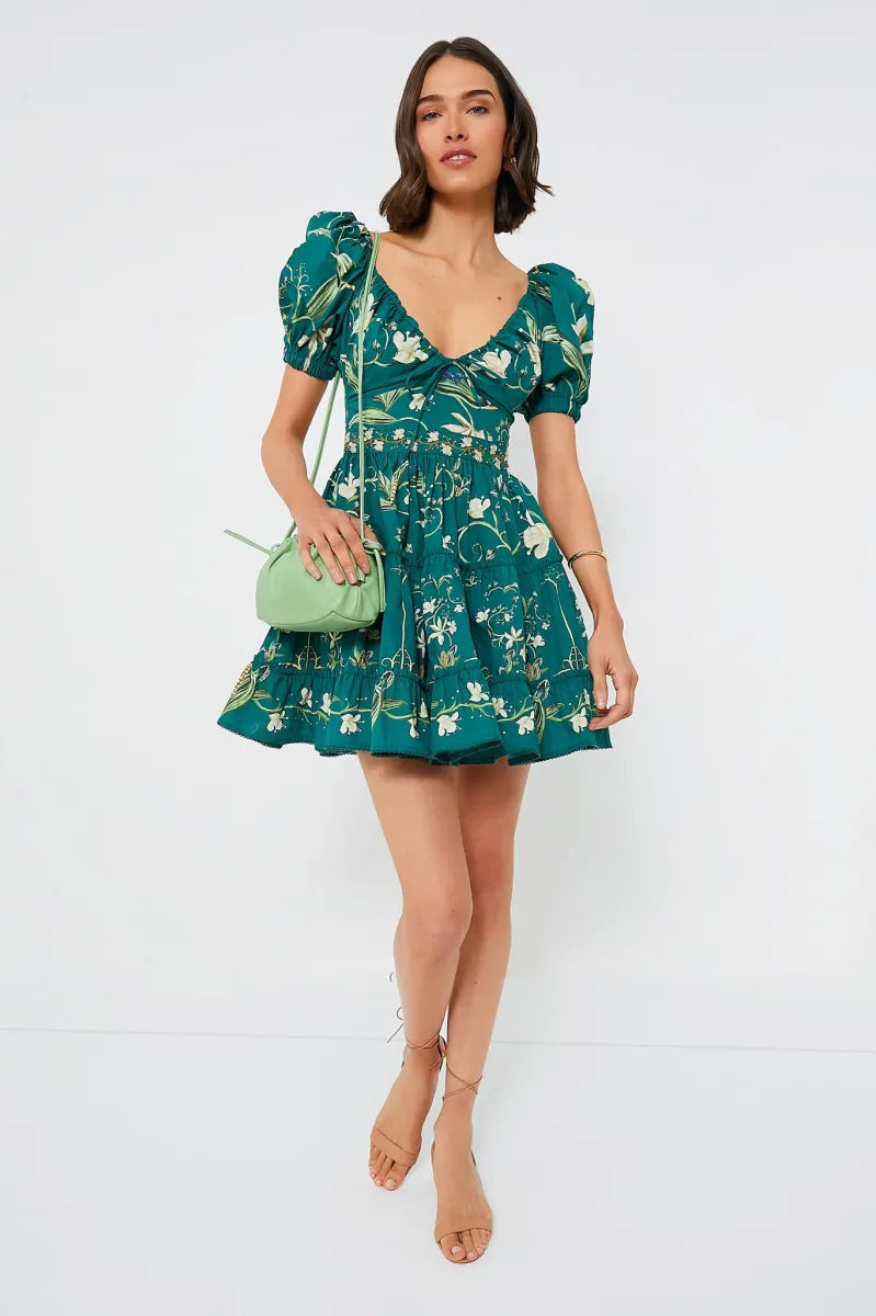 The Esmeralda Manzanilla Mini Dress combines effortless style with comfort, crafted from breathable 100% cotton poplin. Its adjustable deep-v neckline with a delicate drawstring ensures a custom fit, while the hand-embroidered waistline adds a refined artisanal touch. Featuring a concealed back zip for a seamless silhouette, this dress is perfect for warm days and tropical evenings. Elevate your look by pairing it with espadrilles or heels and statement jewelry for a polished, vibrant outfit.