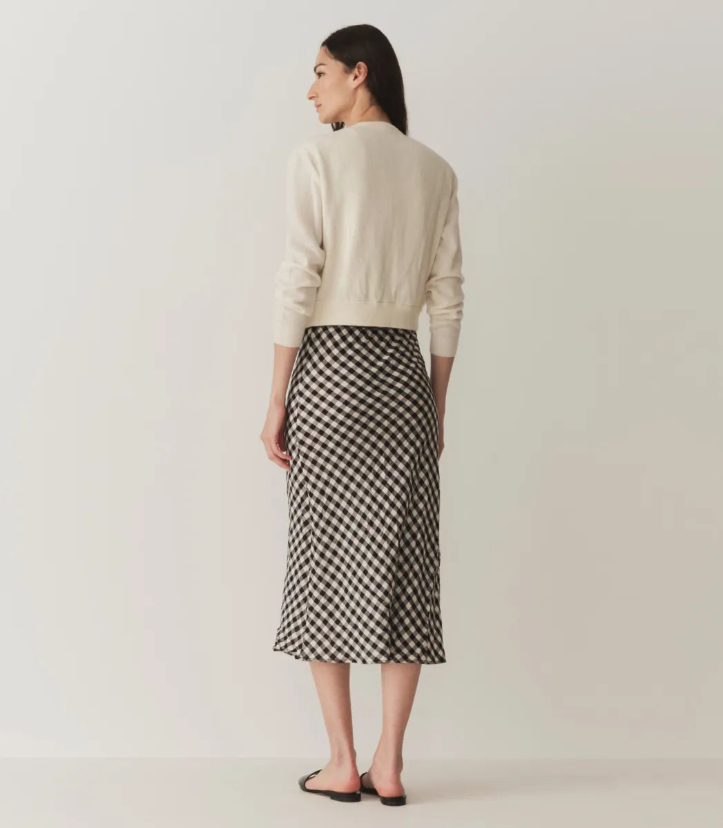 The Elowen Skirt in Marilyn Gingham by Doen offers a refined midi length enhanced by a timeless gingham pattern. Crafted from lightweight fabric, its flowy silhouette ensures comfort without sacrificing style. Versatile enough for casual or formal settings, this skirt pairs seamlessly with diverse tops and accessories, making it a sophisticated staple for any wardrobe seeking effortless elegance.
