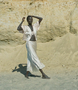 Indulge in timeless elegance with the Elowen Skirt from Doen. This luxurious silk satin skirt features delicate scallop elastic trims and a bias-cut midi design adorned with intricate contrast lace. Its high-waisted silhouette adds a touch of '90s nostalgia, perfect for pairing with the Chantal Top for an elevated matching set. From day to night, embrace sophistication with the Elowen Skirt.