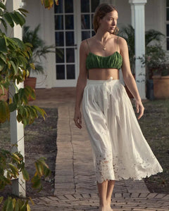 Experience timeless elegance with the Georgina Skirt by Doen. Crafted from organic cotton poplin, this high-waisted A-line skirt features delicate floral embroidery cutwork at the hem for an antique-inspired touch. Convenient side fastenings and a full silhouette falling just above the ankle make this skirt a perfect pairing with the Madison Top.