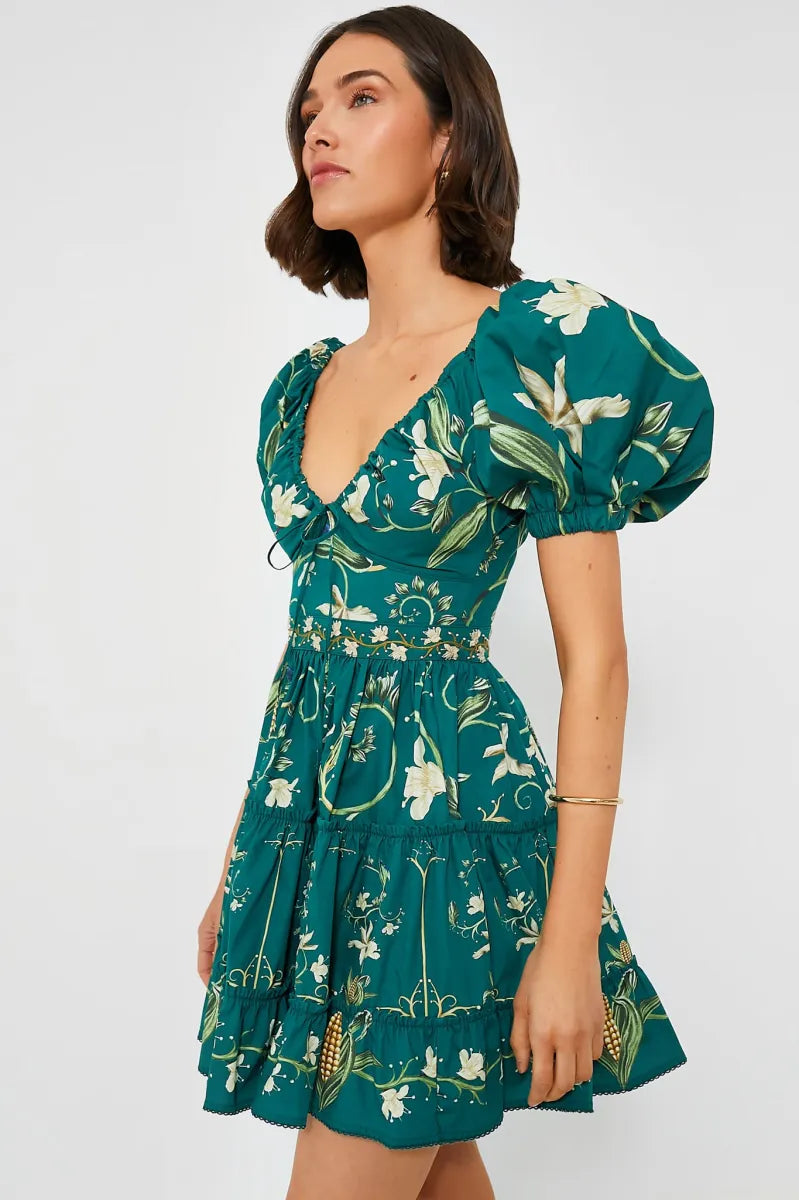 The Esmeralda Manzanilla Mini Dress combines effortless style with comfort, crafted from breathable 100% cotton poplin. Its adjustable deep-v neckline with a delicate drawstring ensures a custom fit, while the hand-embroidered waistline adds a refined artisanal touch. Featuring a concealed back zip for a seamless silhouette, this dress is perfect for warm days and tropical evenings. Elevate your look by pairing it with espadrilles or heels and statement jewelry for a polished, vibrant outfit.