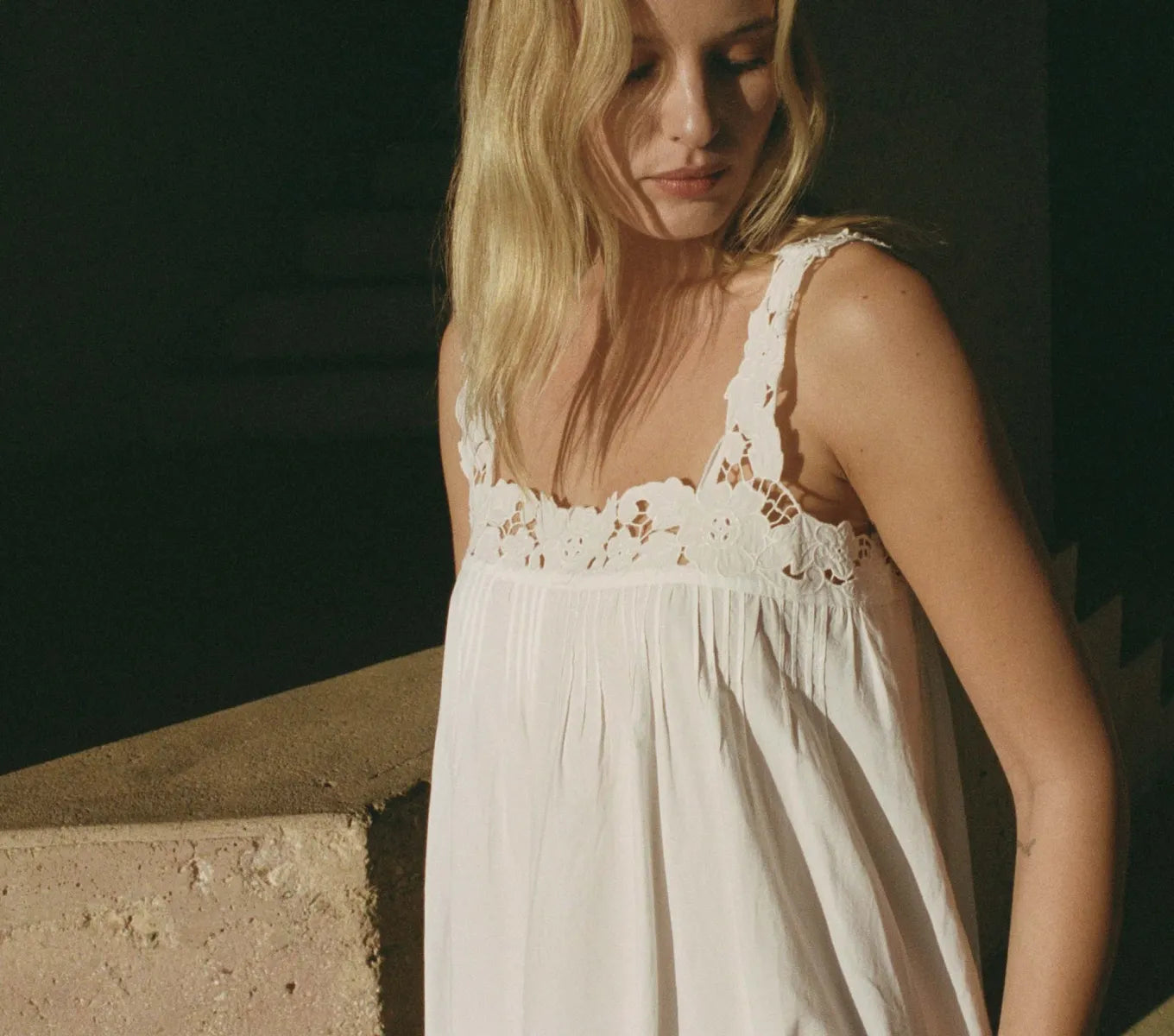 Crafted from organic cotton poplin, the Ellen Dress in Salt showcases expert detailing with a square neckline featuring hand-placed floral embroidery cutwork. Thick straps ensure comfort and support, while the ankle-length hem is enhanced by clustered pintucks and shirring, adding subtle texture. This breathable maxi dress combines refined elegance with effortless wearability, making it an excellent choice for warm-weather occasions that call for both style and comfort.